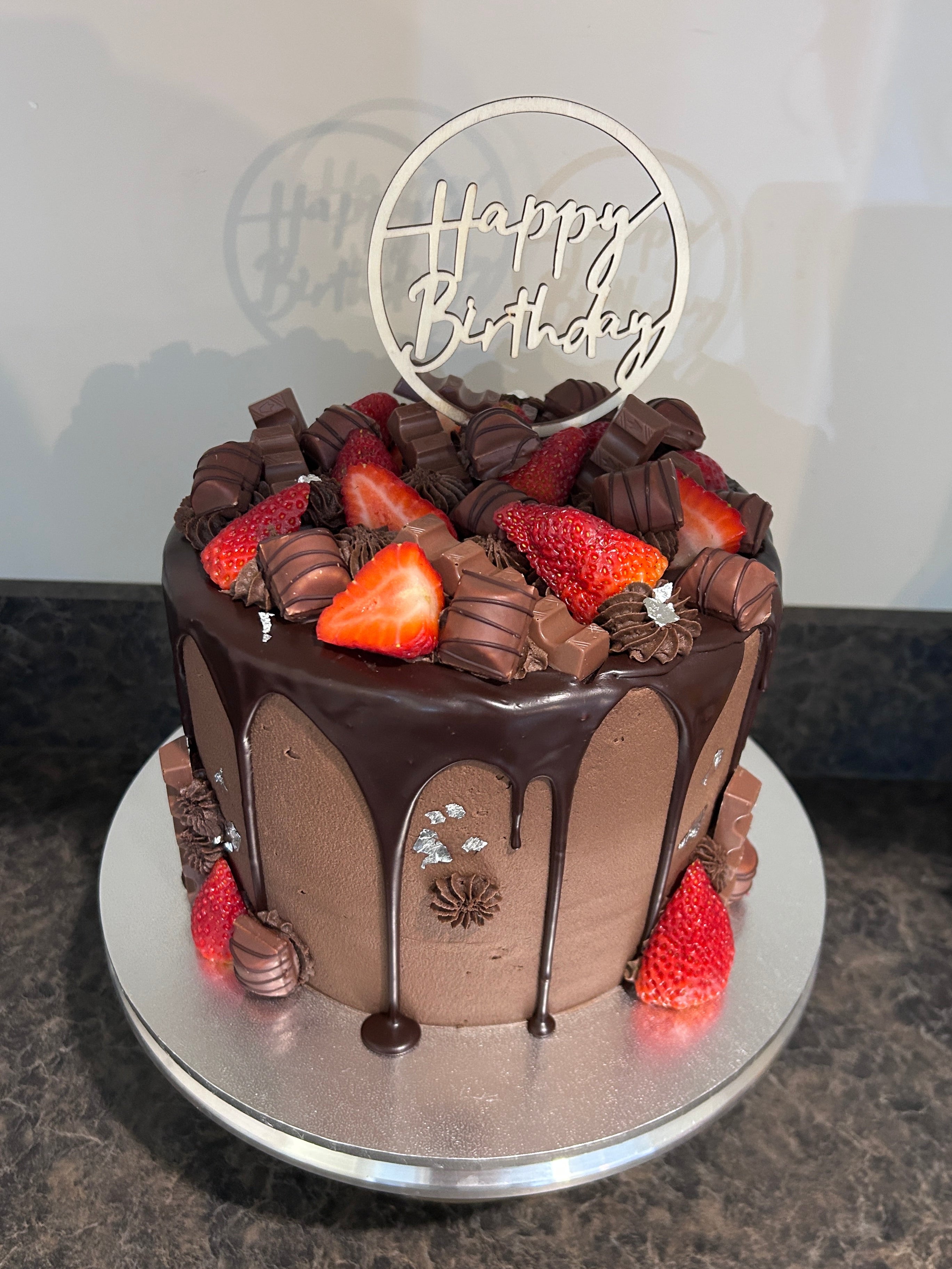 Chocolate cake covered with strawberries and kinder chocolate